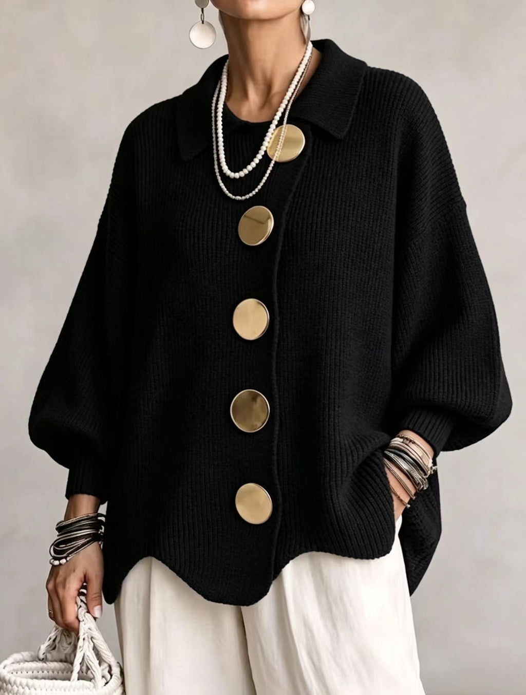 Women's oversized rib knit cardigan with large gold buttons and a scalloped hem