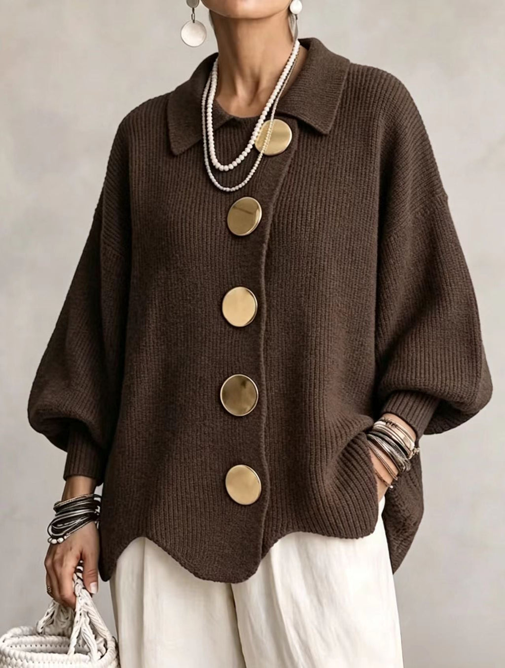 Women's oversized rib knit cardigan with large gold buttons and a scalloped hem