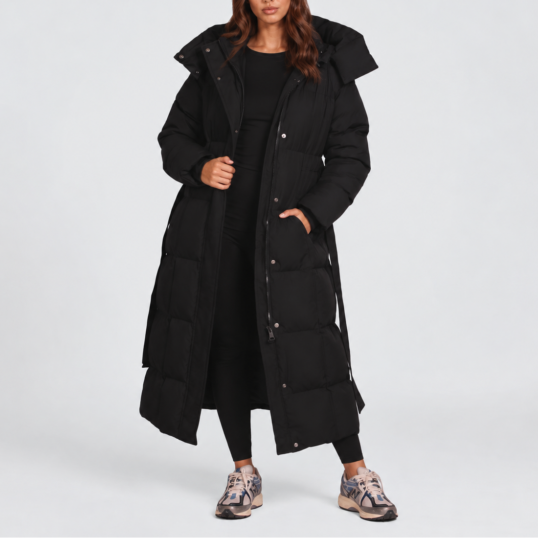 Women's long hooded puffer coat with a tie belt at the waist