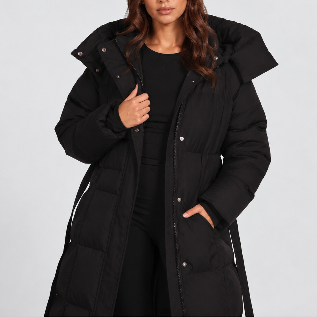 Women's long hooded puffer coat with a tie belt at the waist