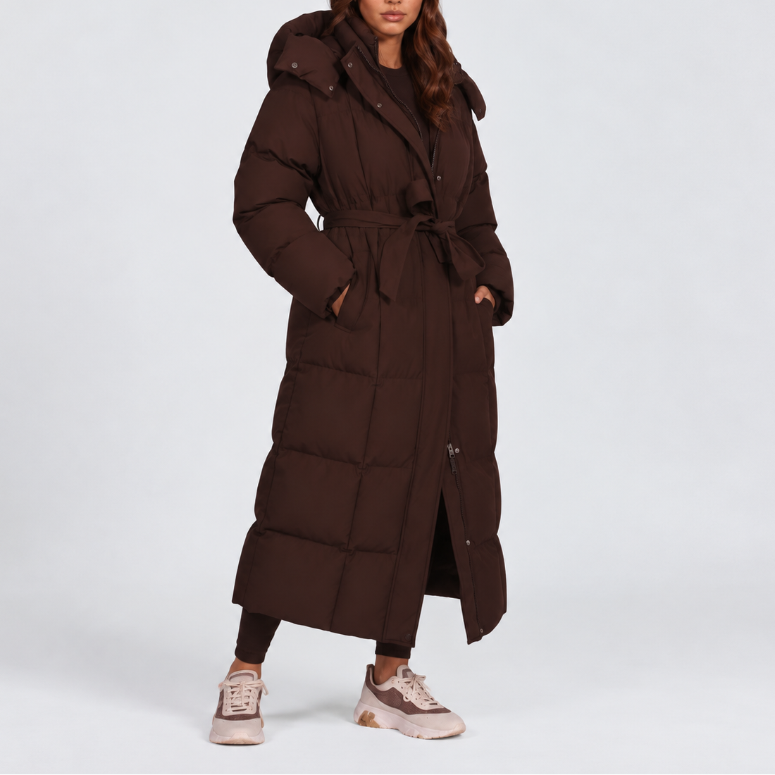 Women's long hooded puffer coat with a tie belt at the waist