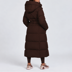 Women's long hooded puffer coat with a tie belt at the waist