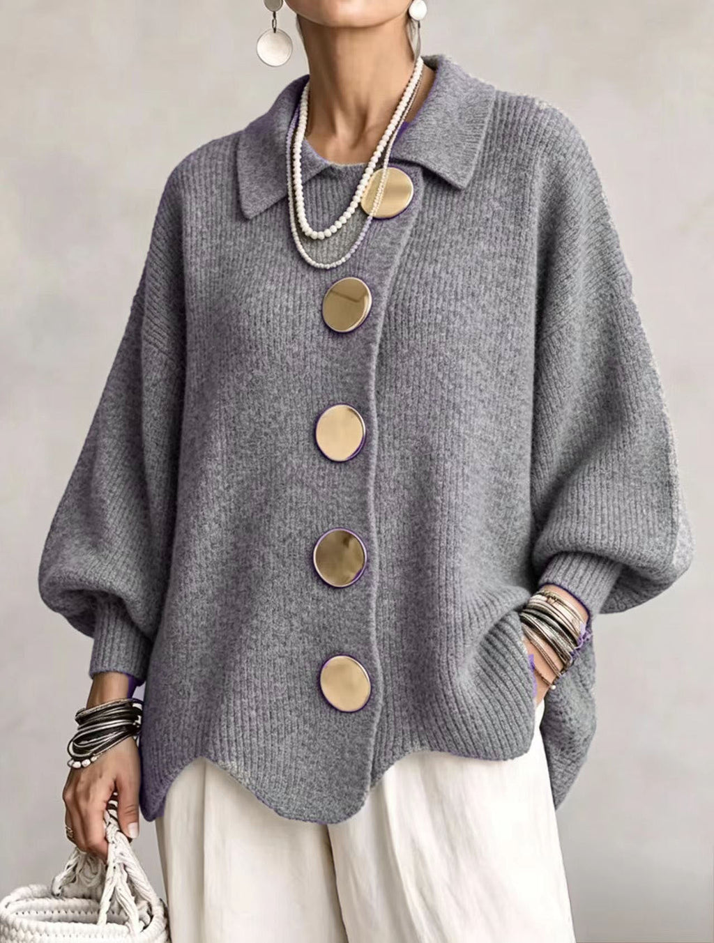 Women's oversized rib knit cardigan with large gold buttons and a scalloped hem