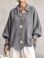 Women's oversized rib knit cardigan with large gold buttons and a scalloped hem