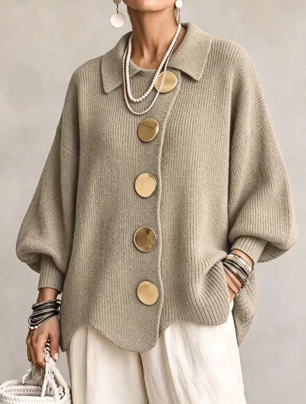 Women's oversized rib knit cardigan with large gold buttons and a scalloped hem