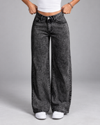 Women's black acid wash jeans with wide leg and mid rise
