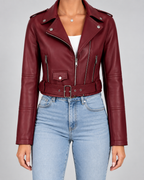 Burgundy cropped faux leather moto jacket styled with jeans