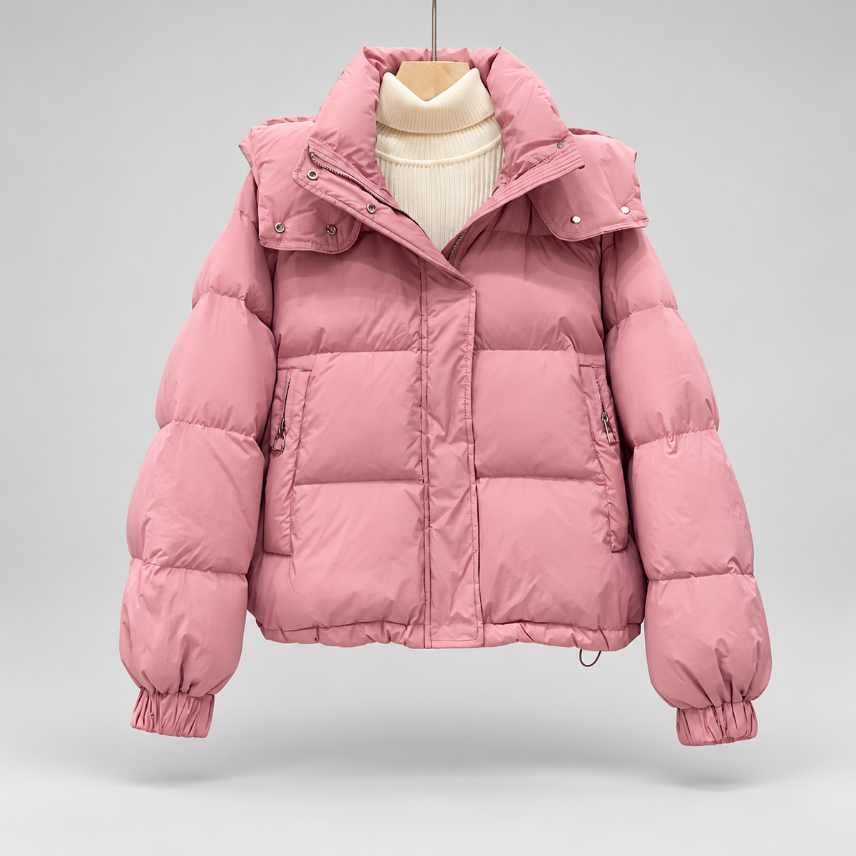 Women's High Neck Puffer Jacket with Hood and Zip Pockets in Pink – Flat Front View