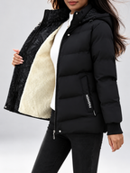 Women's hooded puffer jacket in Black – studio view 13