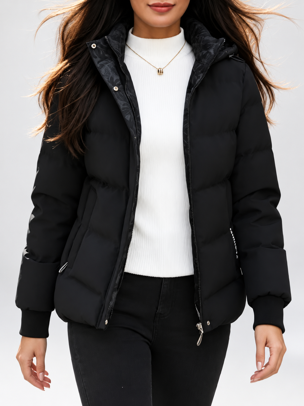 Women's hooded puffer jacket in Black – studio view 14