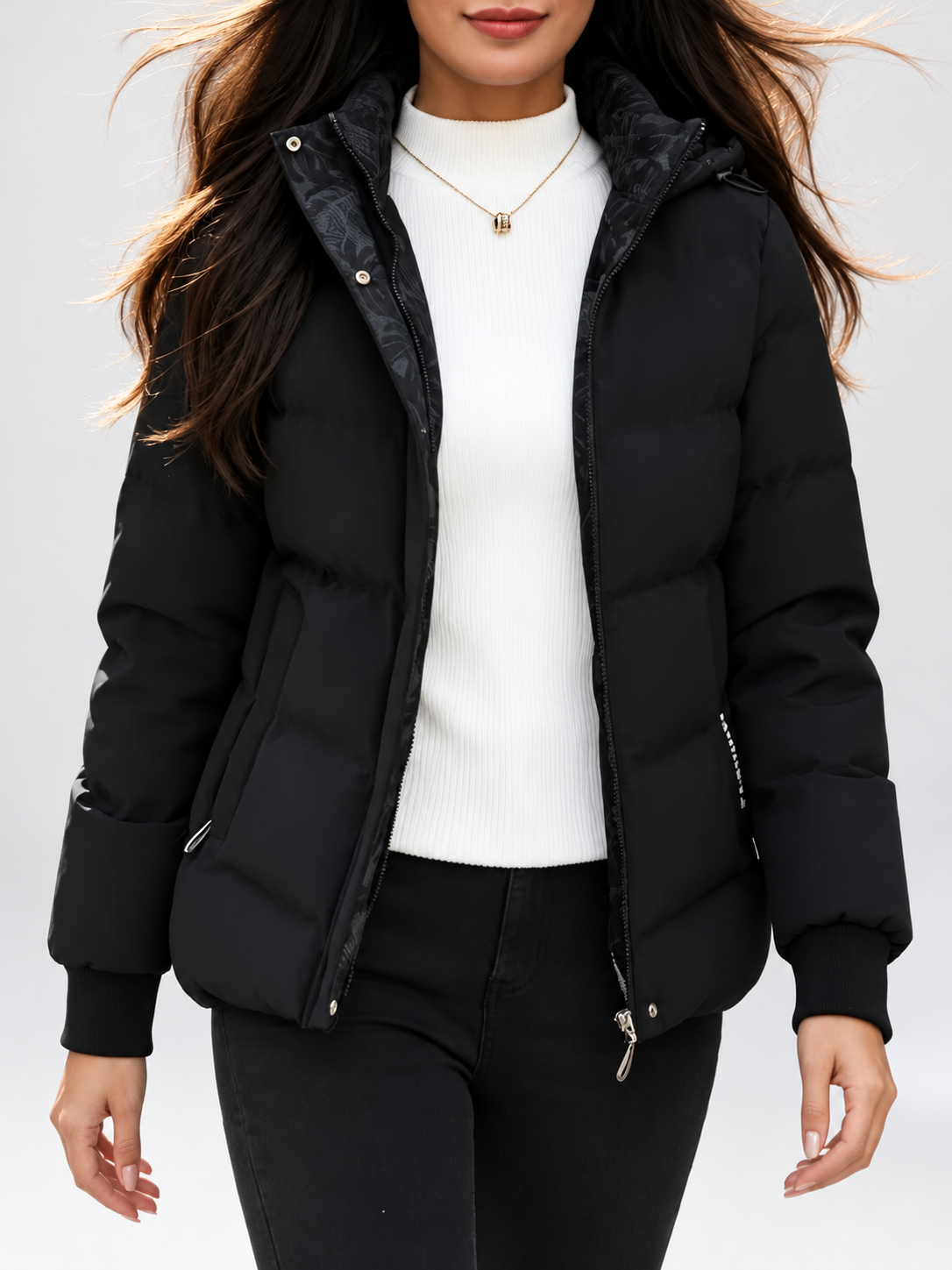 Women's hooded puffer jacket in Black – studio view 14