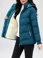 Women's hooded puffer jacket in Blue – studio view 6