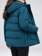 Women's hooded puffer jacket in Blue – studio view 8
