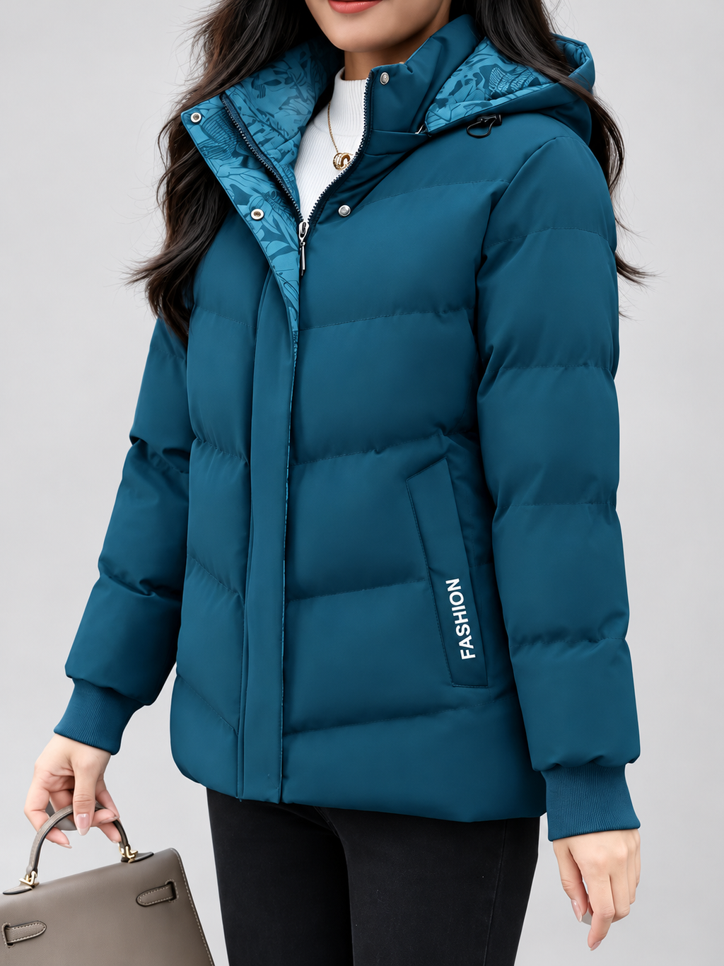 Women's hooded puffer jacket in Blue – studio view 10