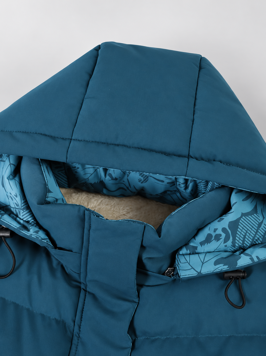Women's hooded puffer jacket in Blue – studio view 11