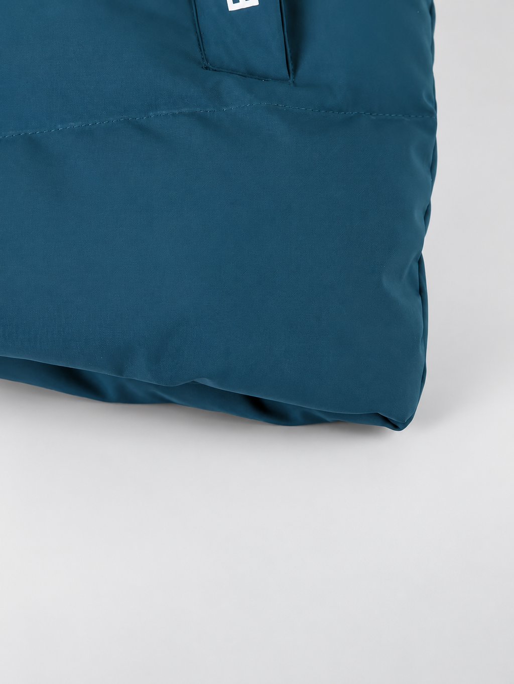 Women's hooded puffer jacket in Blue – studio view 12