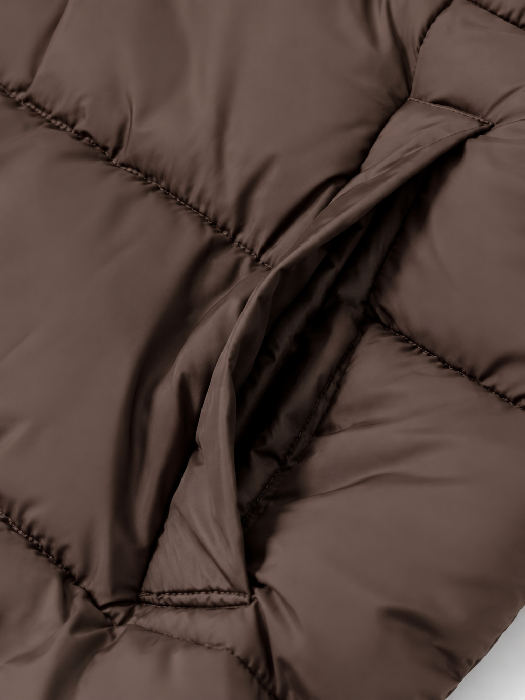 Women's longline hooded puffer coat in Brown – pocket detail