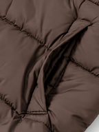 Women's longline hooded puffer coat in Brown – pocket detail