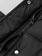 Women's longline hooded puffer coat in Black – two way zip snap detail