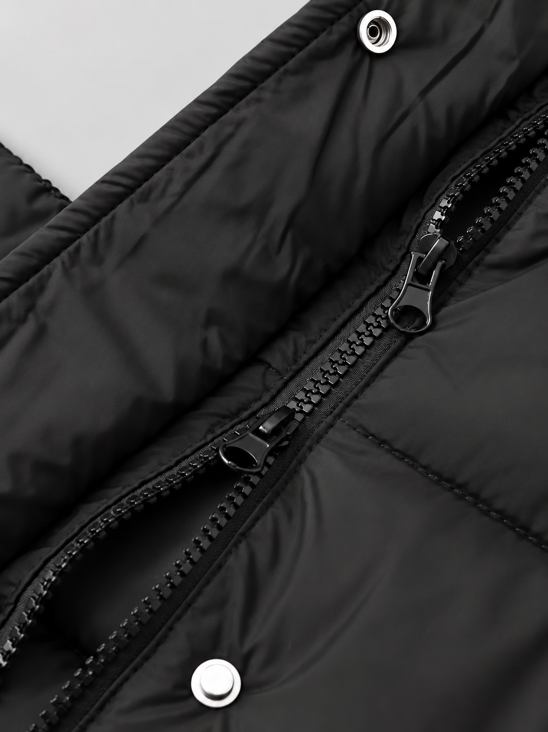 Women's longline hooded puffer coat in Black – two way zip snap detail