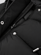 Women's longline hooded puffer coat in Black – zip snap detail