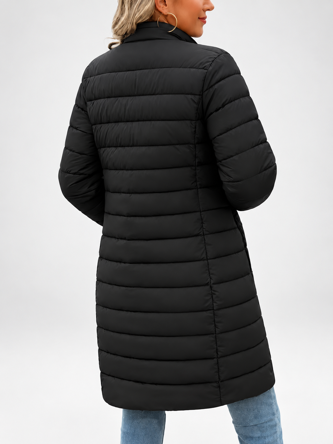 Women's longline puffer coat in black, three-quarter view