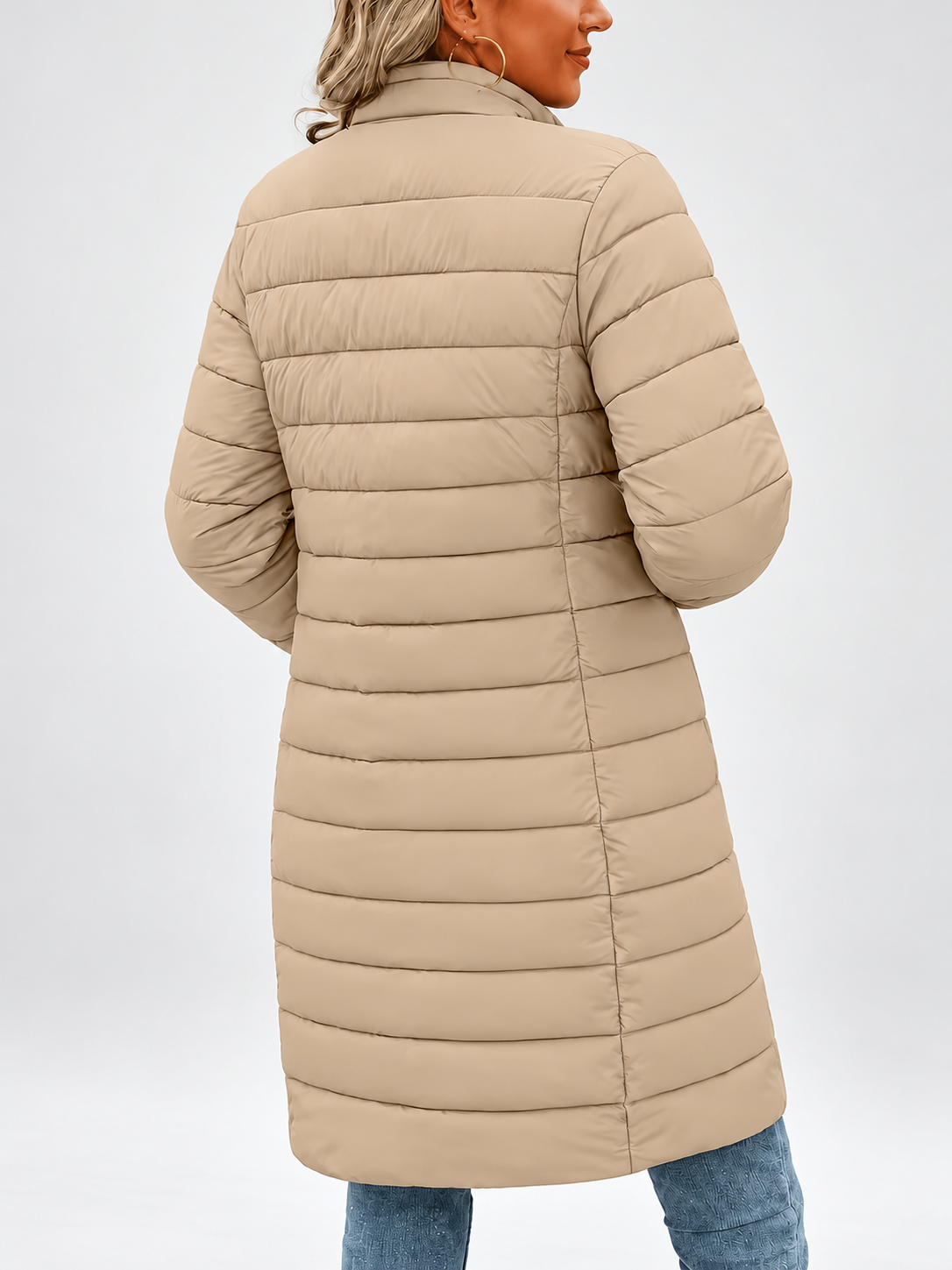 Women's longline puffer coat in khaki, front view with a coffee cup