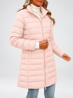 Women's longline puffer coat in light pink, front view with a coffee cup