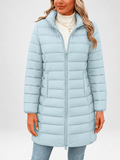 Women's longline puffer coat in sky blue, front view with stand collar and zip fastening