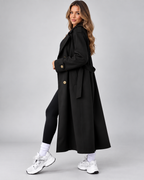 Black double breasted trench coat styled with leggings