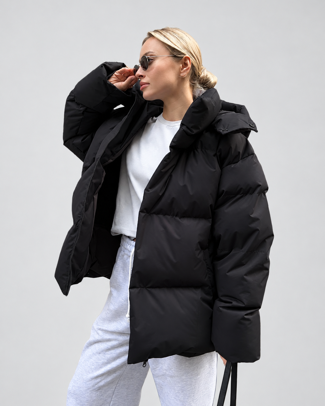 Women's Oversized Hooded Puffer Jacket with High Collar and Wide Quilting in Black – Front View