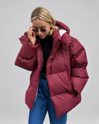 Women's Oversized Hooded Puffer Jacket with High Collar and Wide Quilting in Burgundy – Front View