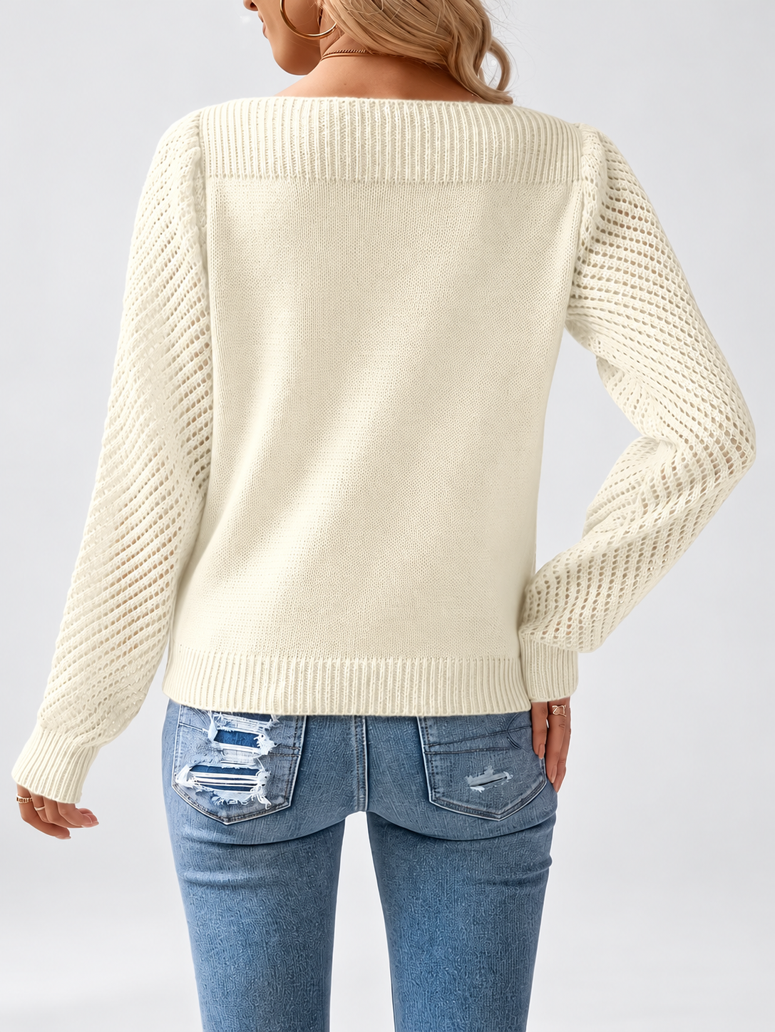 Women's round neck knitted jumper in Apricot, back view with open knit sleeves