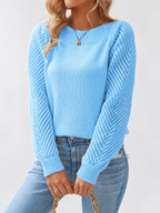 Women's round neck knitted jumper in Blue, seated view with open knit sleeves